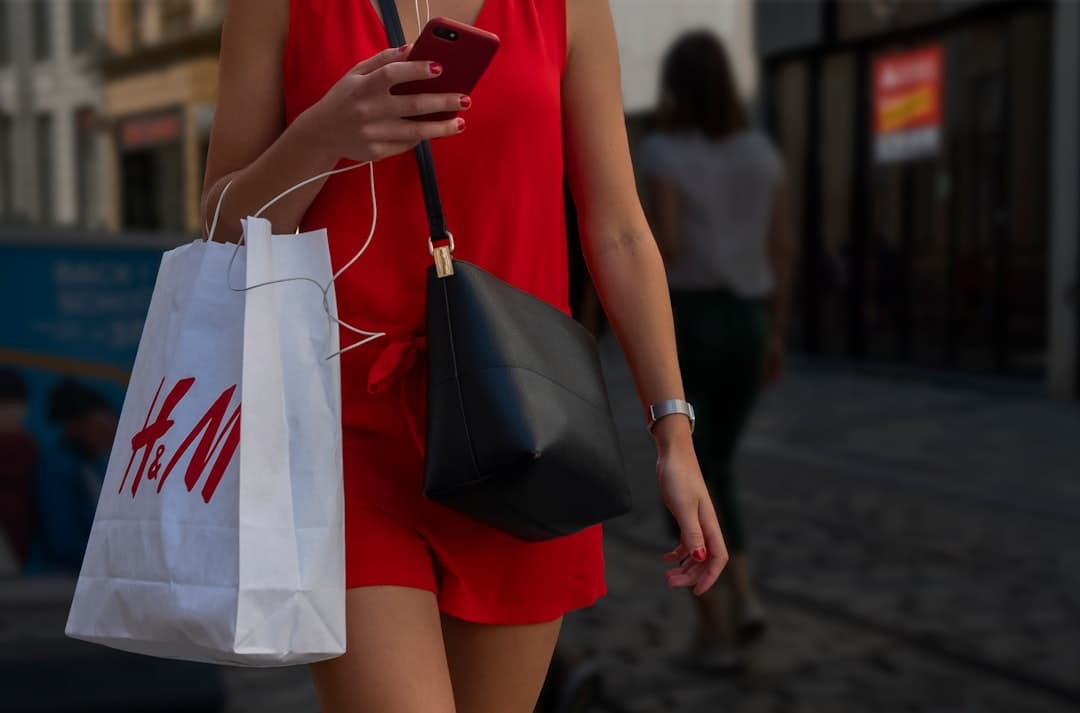 Person shopping on smartphone with various mobile shopping apps and payment options displayed
